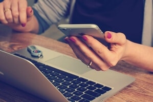 Picture of woman on computer and phone