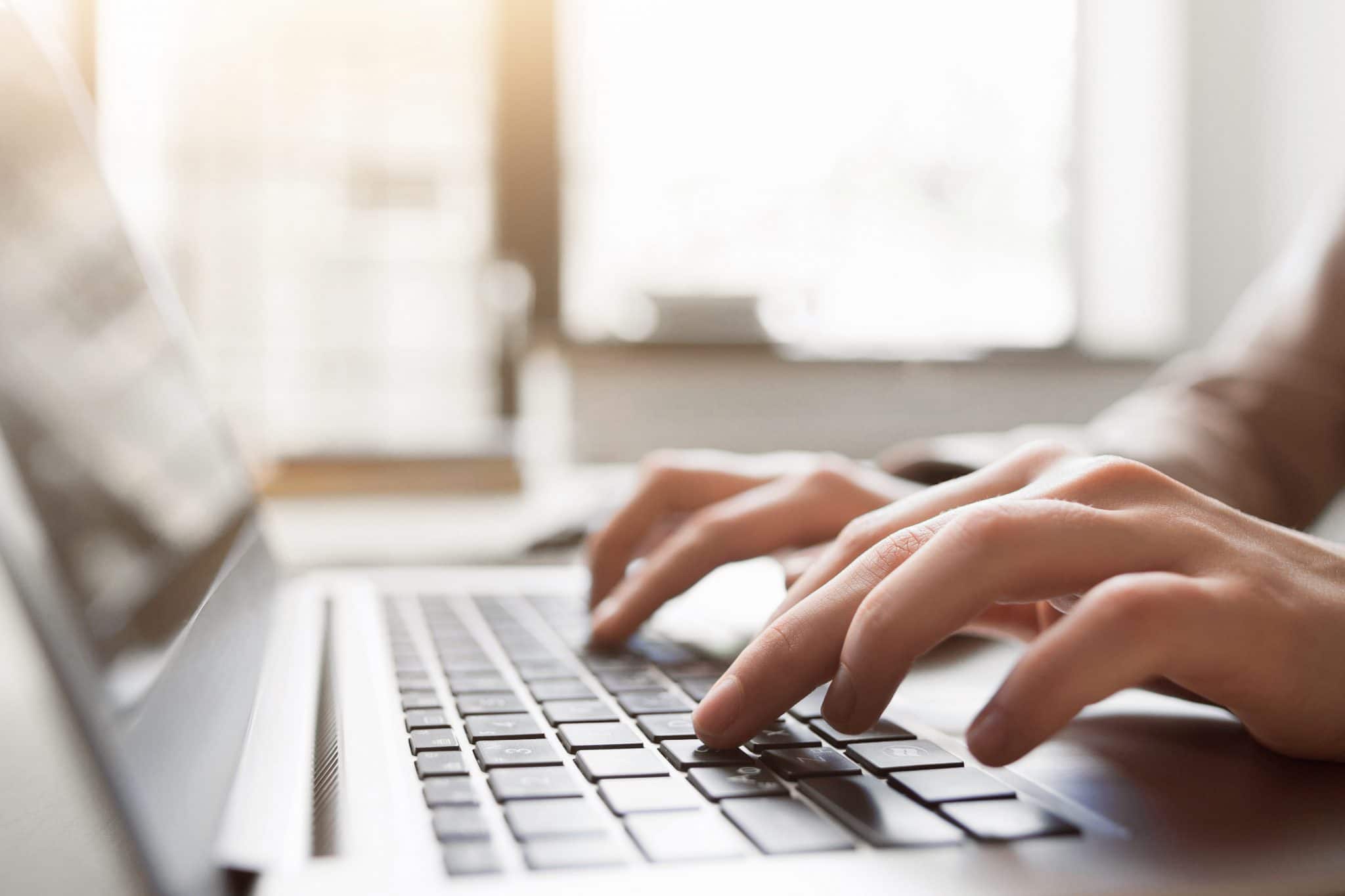 Picture of hands typing on laptop