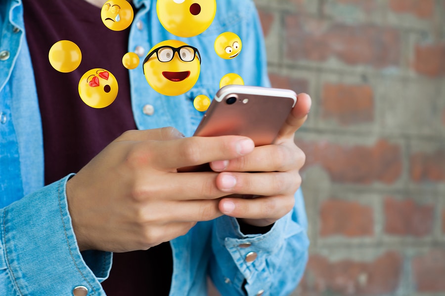 Picture of person communicating with emojis