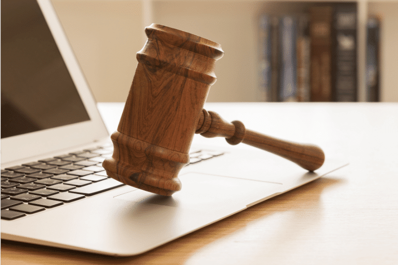 Image of a laptop and gavel - can social media evidence be used in court?